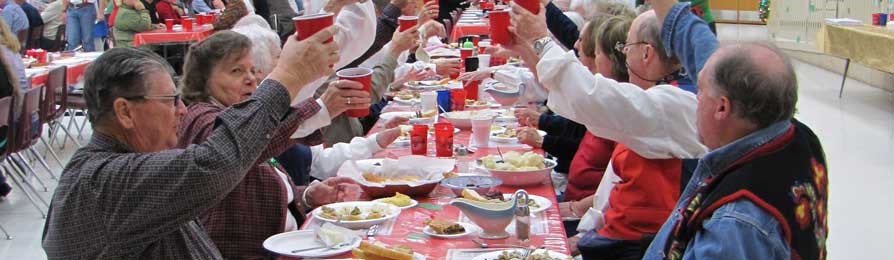 Fair Use credit: Norwegian Society of Texas, including Steve Ogden, toasting at Cranfills Gap Lutefisk Supper